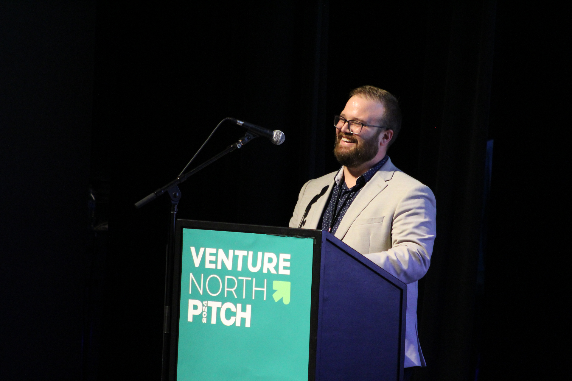 Winner being celebrated at the Venture North PITCH 2025 podium with the host team.