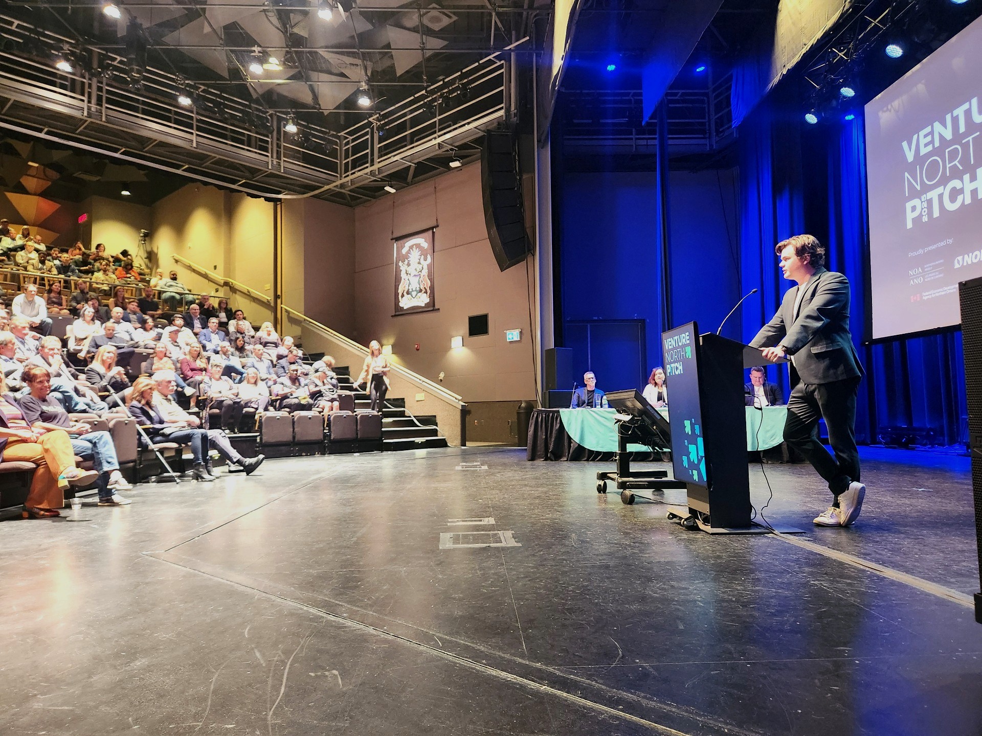 Speaker pitching on stage at Venture North PITCH 2025